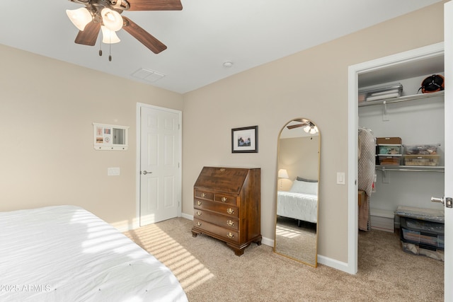 carpeted bedroom with ceiling fan and a closet