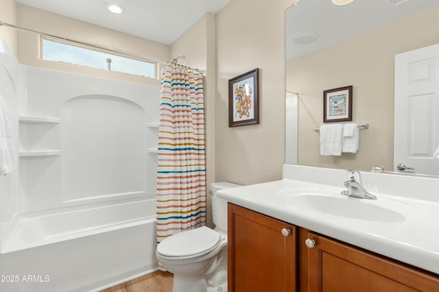 full bathroom with hardwood / wood-style flooring, vanity, shower / bath combo, and toilet