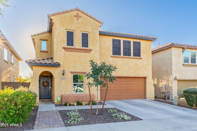 mediterranean / spanish home featuring a garage