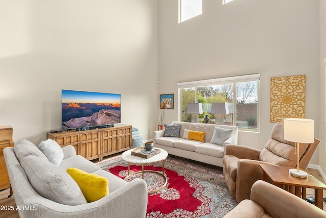 living room with hardwood / wood-style flooring and a high ceiling