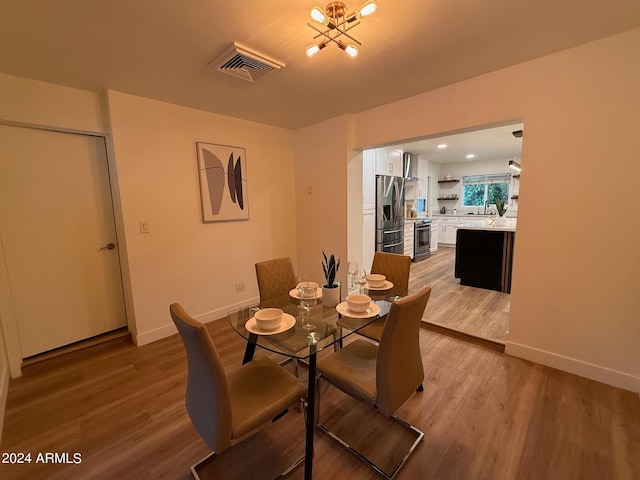 dining space with sink and hardwood / wood-style floors