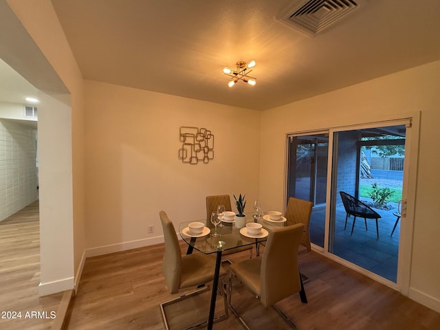 dining space with hardwood / wood-style floors