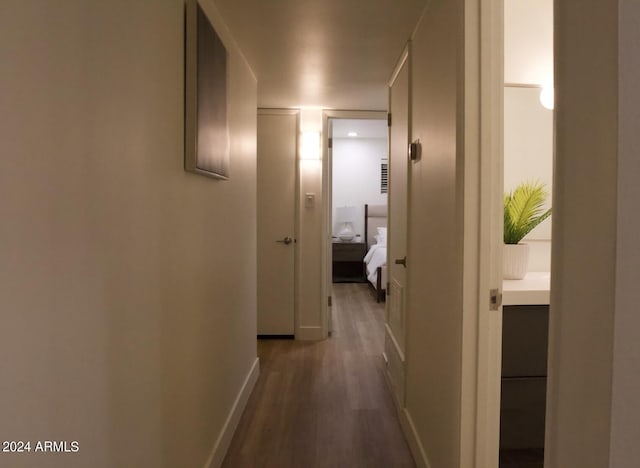 corridor with hardwood / wood-style floors