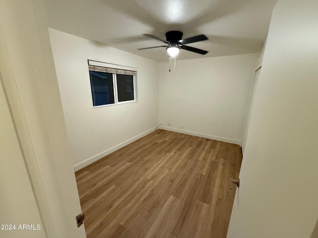 unfurnished room featuring light wood-type flooring and ceiling fan