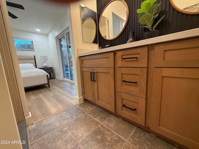 bathroom featuring wood-type flooring, vanity, and ceiling fan