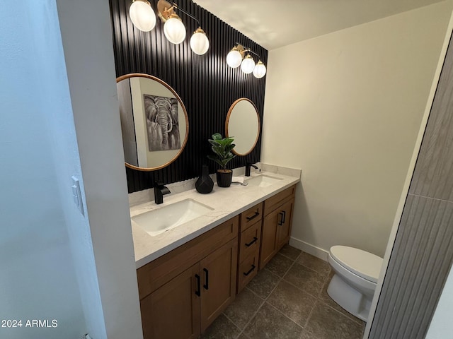 bathroom with vanity, tile patterned flooring, and toilet