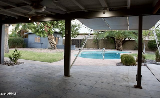 view of pool with a patio and ceiling fan