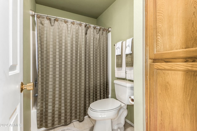 bathroom with toilet, shower / bath combination with curtain, and tile patterned floors