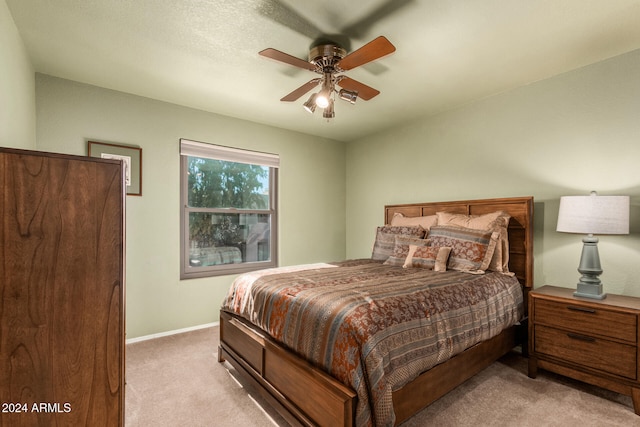 bedroom with light colored carpet and ceiling fan