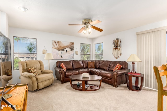 carpeted living room featuring ceiling fan and a wealth of natural light