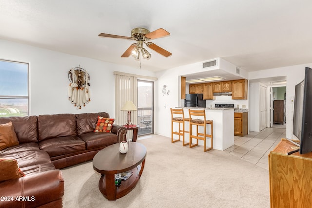 living room featuring light colored carpet and ceiling fan