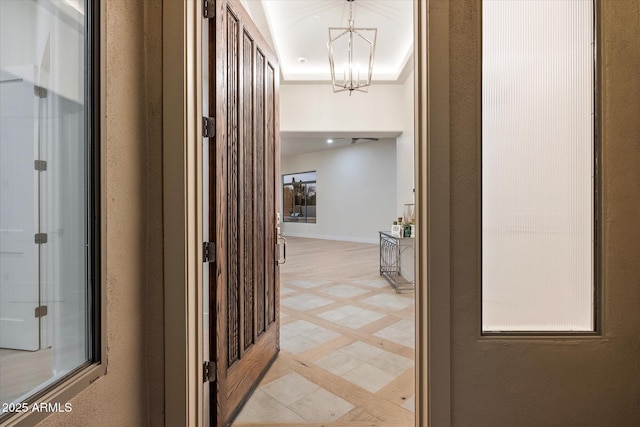 hallway with a notable chandelier