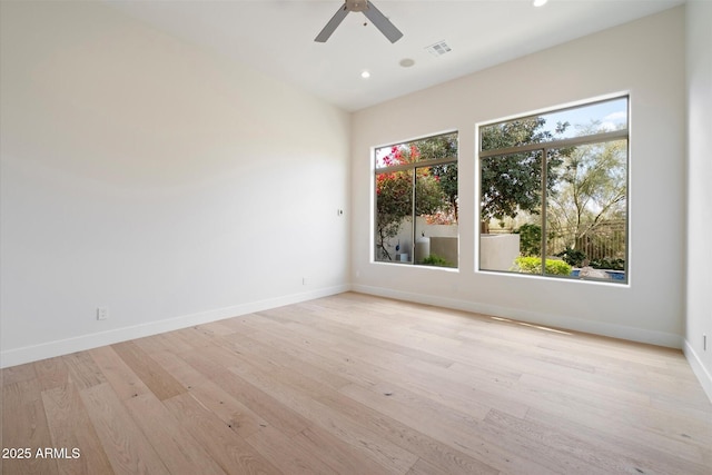 unfurnished room with ceiling fan, a healthy amount of sunlight, and light wood-type flooring