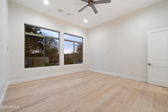 unfurnished room with ceiling fan and light wood-type flooring