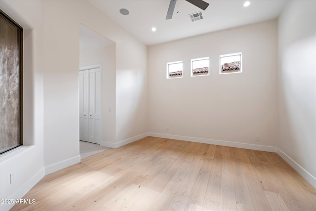 spare room featuring ceiling fan and light hardwood / wood-style flooring