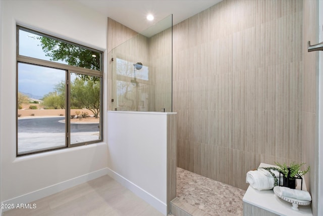 bathroom with a wealth of natural light and tiled shower