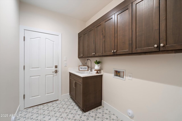 washroom with sink, hookup for a washing machine, and cabinets