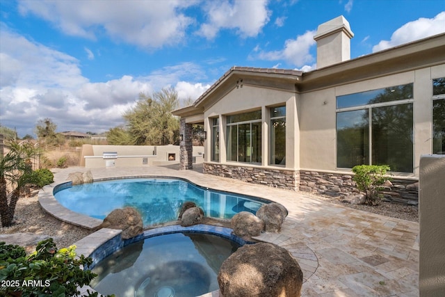 view of pool with a patio and an in ground hot tub