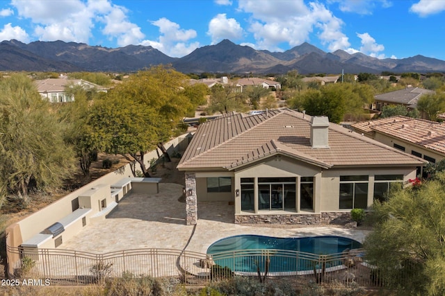 rear view of property featuring a patio and a mountain view