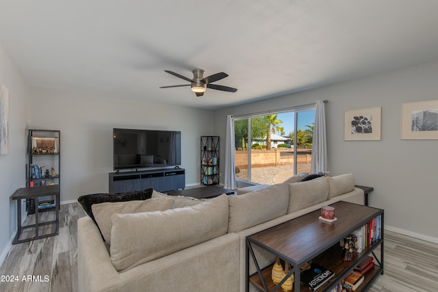 living room featuring light wood-type flooring and ceiling fan