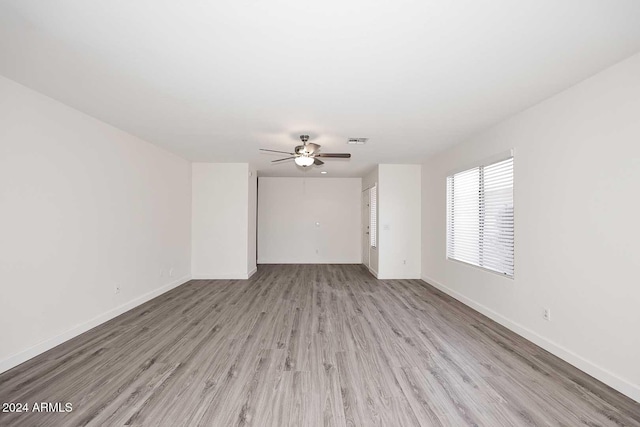 spare room featuring light hardwood / wood-style flooring and ceiling fan