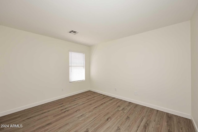 unfurnished room featuring hardwood / wood-style floors