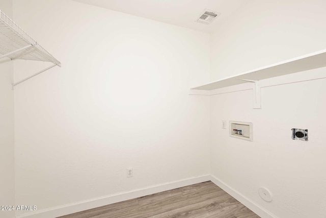 laundry room with hookup for a washing machine, hardwood / wood-style flooring, gas dryer hookup, and electric dryer hookup