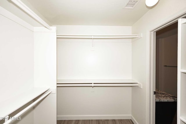 spacious closet featuring hardwood / wood-style floors