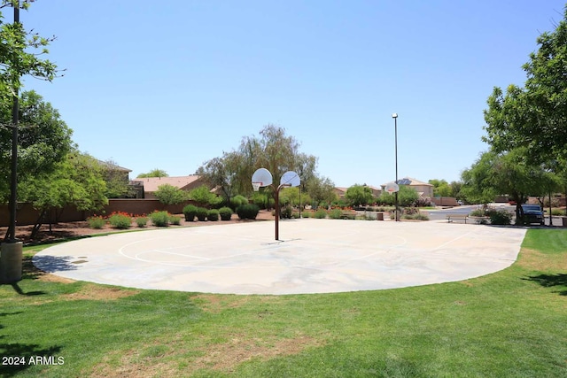 view of sport court featuring a lawn