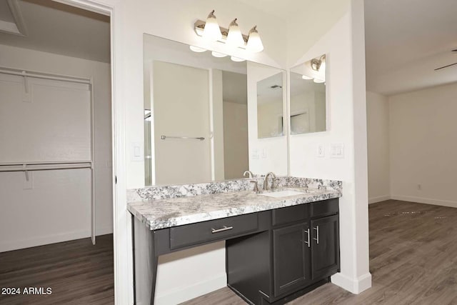 bathroom with vanity, hardwood / wood-style floors, and ceiling fan