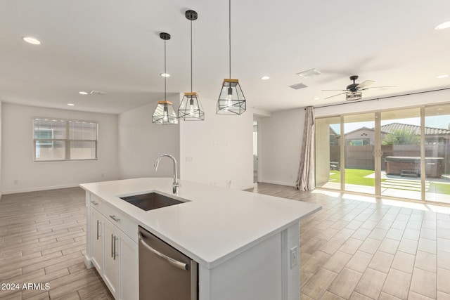 kitchen with dishwasher, sink, an island with sink, decorative light fixtures, and white cabinets