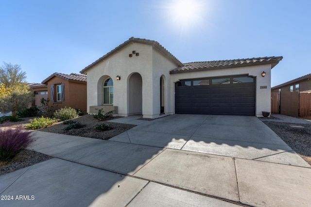 mediterranean / spanish-style house with a garage