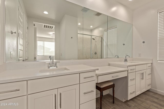 bathroom featuring vanity, a shower with shower door, and hardwood / wood-style flooring