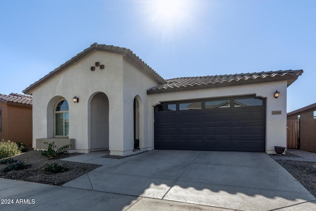 mediterranean / spanish house featuring a garage