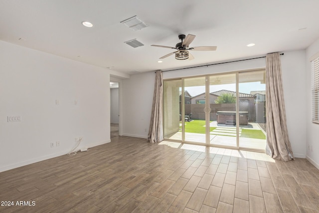 unfurnished room with ceiling fan and light hardwood / wood-style floors