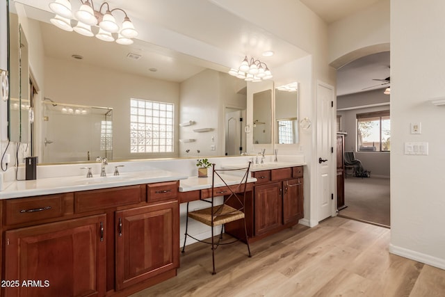 bathroom with hardwood / wood-style flooring, vanity, and ceiling fan