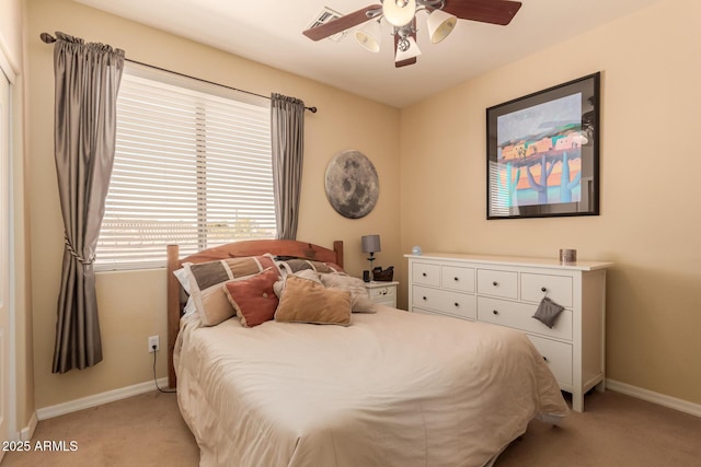 bedroom with ceiling fan and light carpet