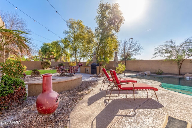 view of patio featuring a fenced in pool and grilling area