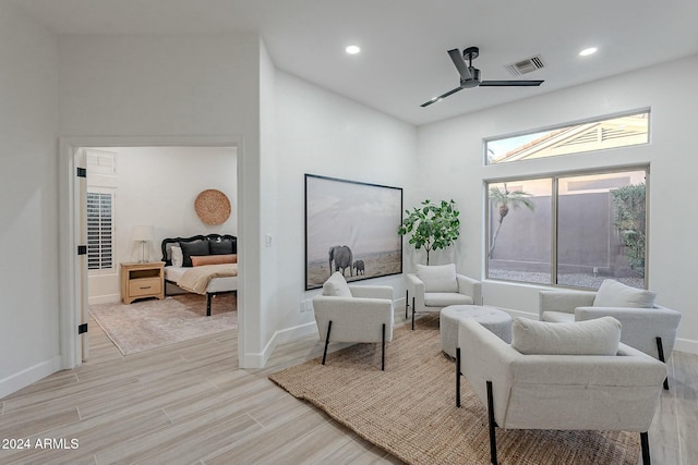 living room featuring high vaulted ceiling, light hardwood / wood-style flooring, and ceiling fan