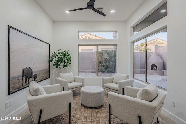 living room with light hardwood / wood-style flooring and ceiling fan