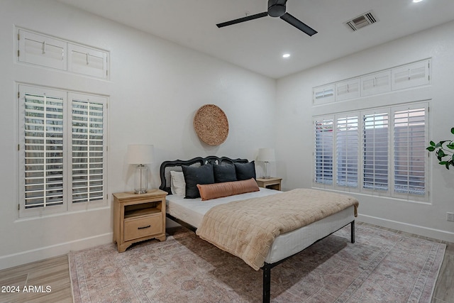 bedroom with light hardwood / wood-style floors and ceiling fan