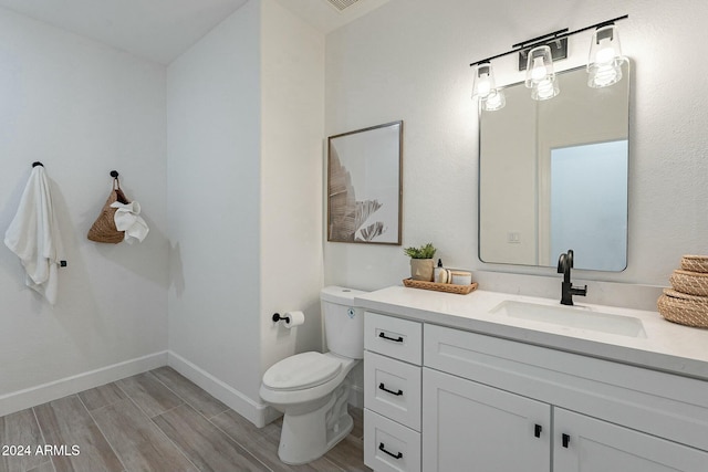 bathroom featuring hardwood / wood-style floors, vanity, and toilet