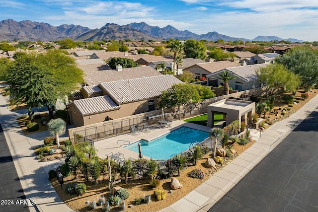 view of swimming pool featuring a mountain view and a patio