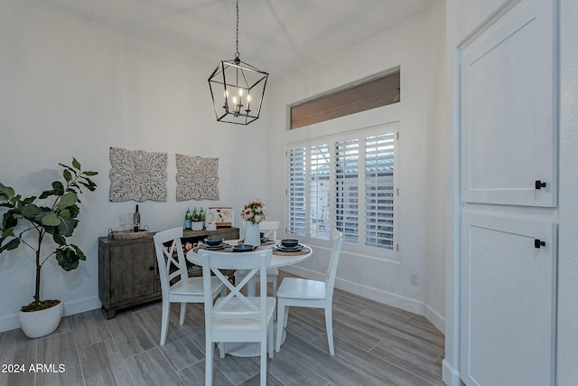 dining room featuring light hardwood / wood-style flooring and a chandelier