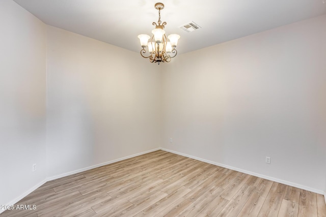 9165 W Mine Trl, Peoria, AZ 85383 - empty room featuring light wood-style floors, a chandelier, and baseboards