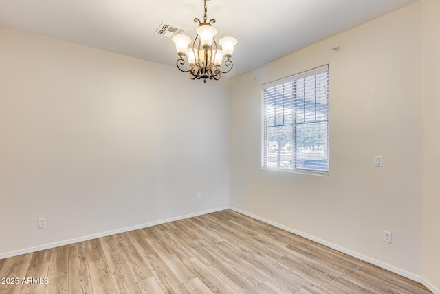 9165 W Mine Trl, Peoria, AZ 85383 - unfurnished room featuring a chandelier, light wood-style floors, and baseboards