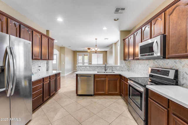 9165 W Mine Trl, Peoria, AZ 85383 - kitchen with appliances with stainless steel finishes, a sink, tasteful backsplash, light countertops, and recessed lighting