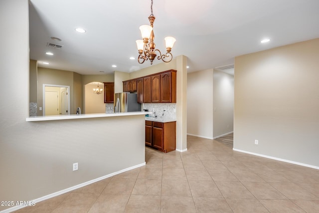 9165 W Mine Trl, Peoria, AZ 85383 - kitchen with a chandelier, freestanding refrigerator, light countertops, recessed lighting, and baseboards