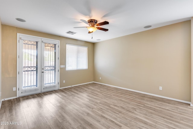 9165 W Mine Trl, Peoria, AZ 85383 - empty room featuring french doors, a ceiling fan, light wood finished floors, and baseboards
