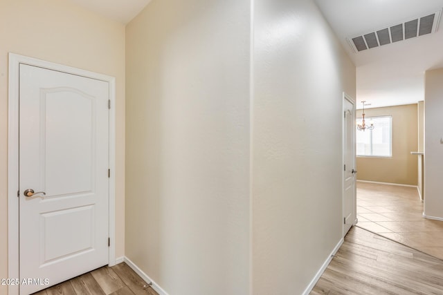 9165 W Mine Trl, Peoria, AZ 85383 - hall with light wood-style flooring, baseboards, and a chandelier